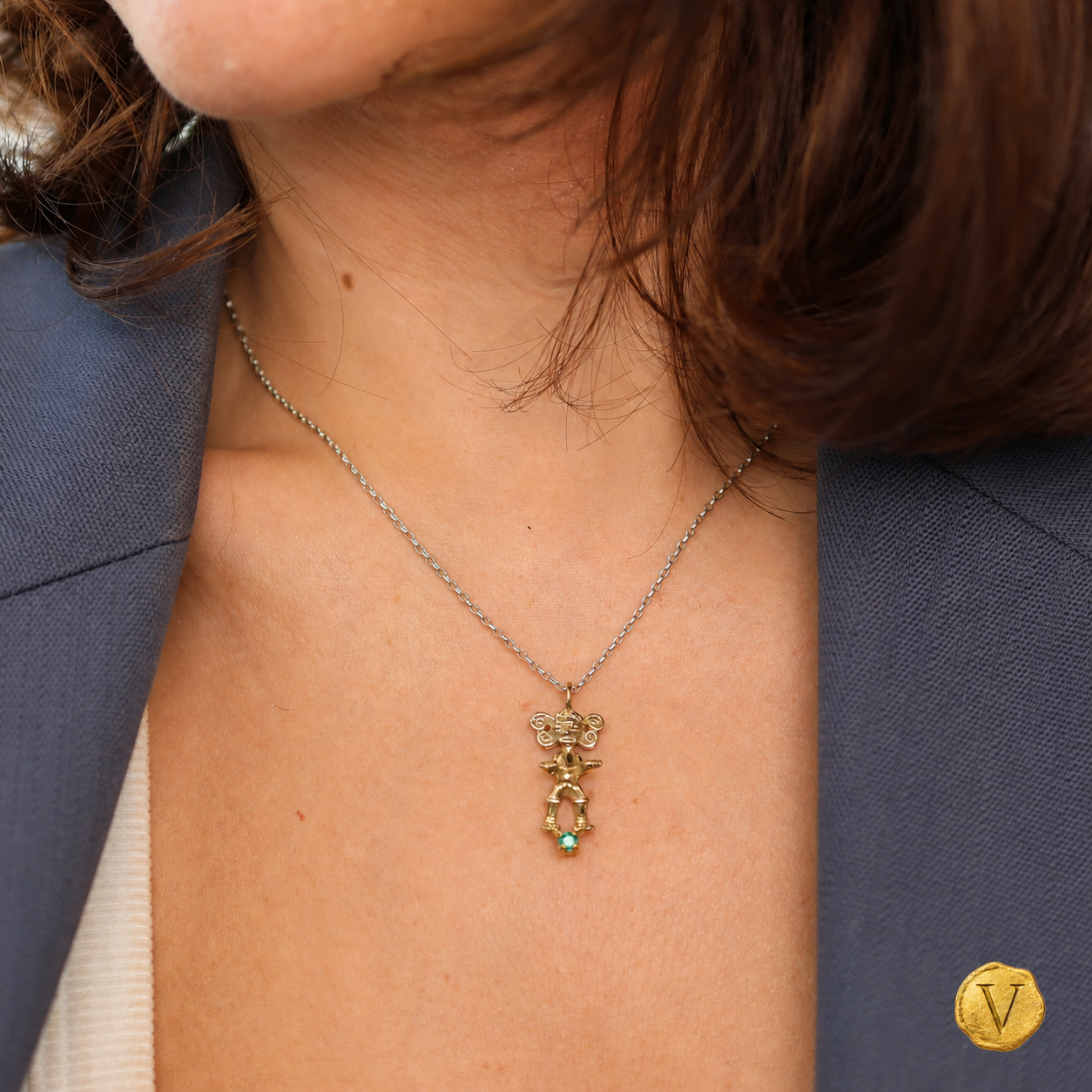 The 9ct gold figurine pendant worn at the neckline with Victoire seal